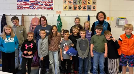 AAACU Team members taking a selfie as they clean up trash in their community